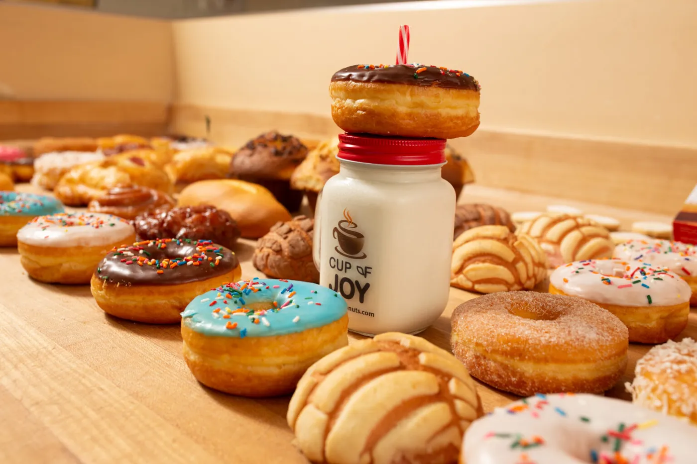 Winstar donuts and conchas around a Cup of Joy mug